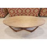 A 1960s - 1970s teak and laminate oval coffee table, 122 cm x 57 cm x 38 cm