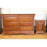 A contemporary mahogany effect bedroom suite comprising a wide chest of drawers, bedside cabinet and