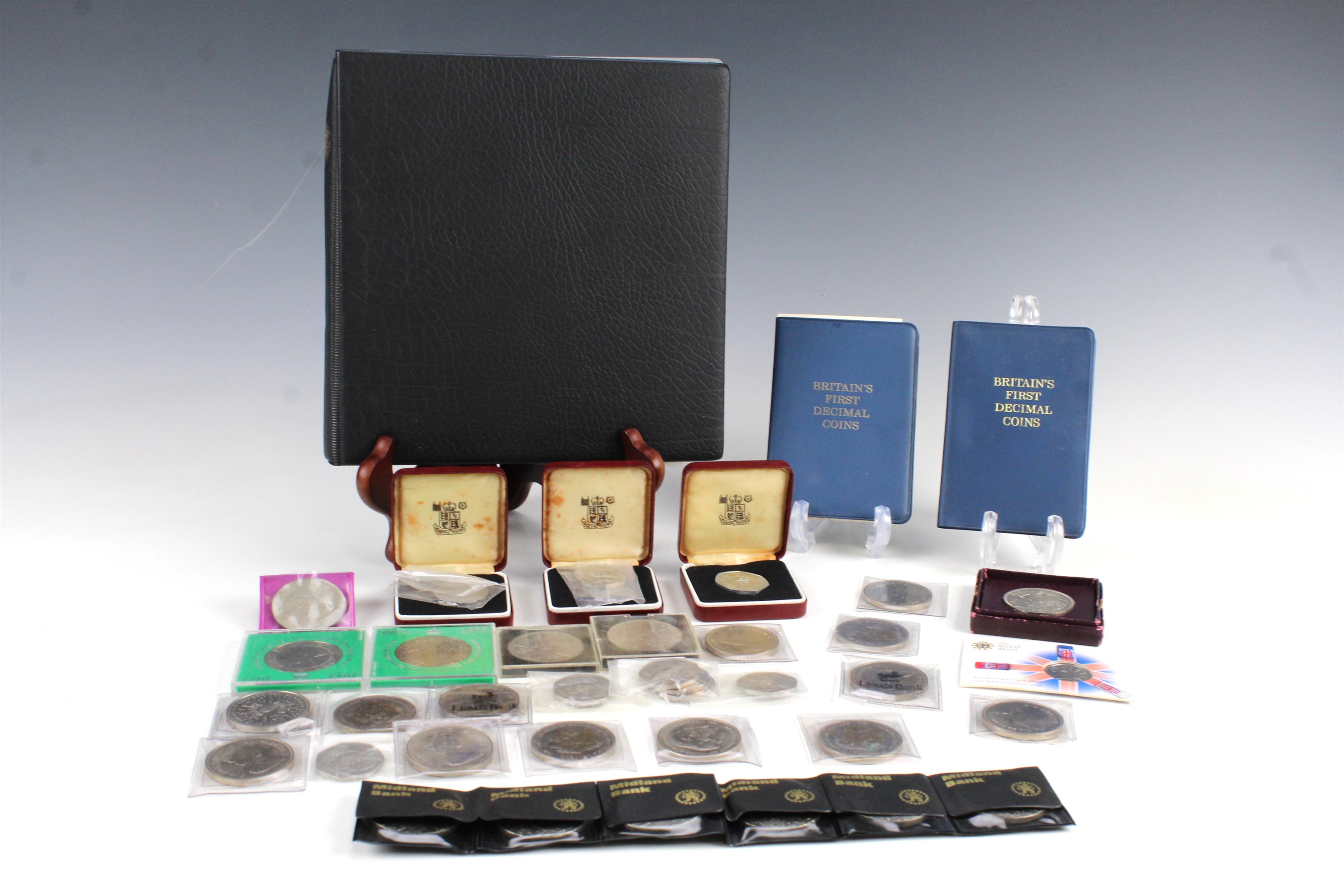 A folder containing GB and world coins, together with a quantity of commemoratives etc
