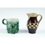 A late 19th Century checker board mocha ware creamer, together with a small fish pattern green