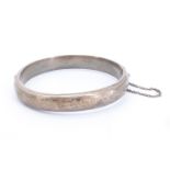 A mid 20th Century silver bracelet, having bright cut decoration and hinged with a box clasp,