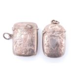 Two silver fob vesta cases, each of cushion form decorated with foliate scroll engraving centred