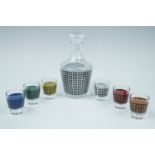 A French pressed glass and polychrome geometrically decorated spirit decanter and glasses,