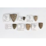 Six Medieval shield shaped lead trade weights, variously bearing lions rampant, and an ewer, 2.5 cm,
