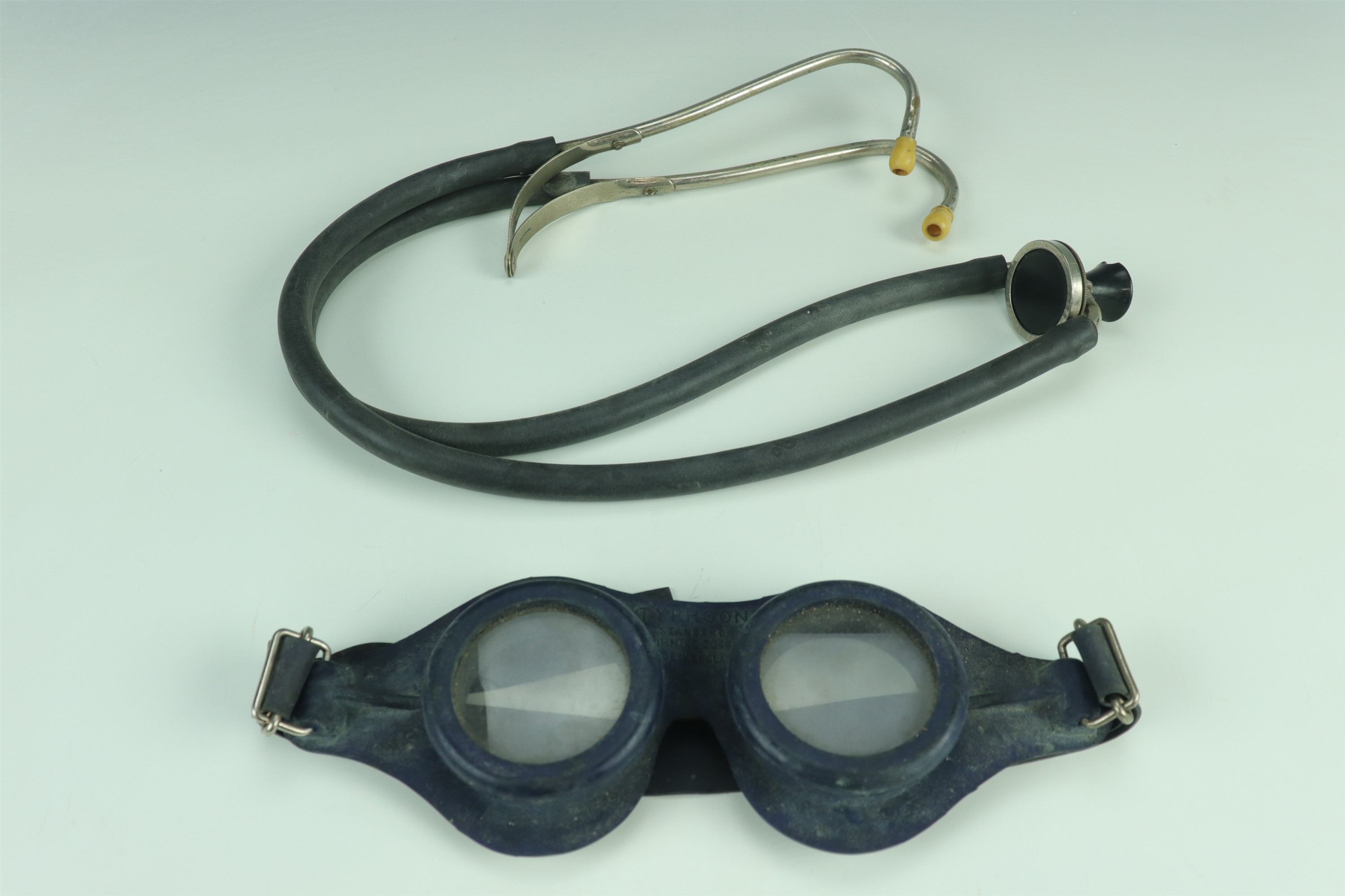A set of vintage Typhoon swimming goggles together with a medical stethoscope