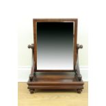 An early Victorian mahogany swivel toilet mirror