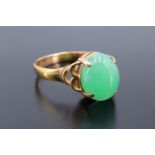 A jade cabochon ring, the oval stone claw-set on 18 K yellow metal, cabochon 10 mm x 8 mm, N/O. 2.