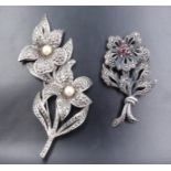 A white metal marcasite floral brooch, set with a cluster of six garnets, and a similar costume