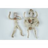 A pair of vintage German Christmas cracker dolls, each having a bisque head and wire armature