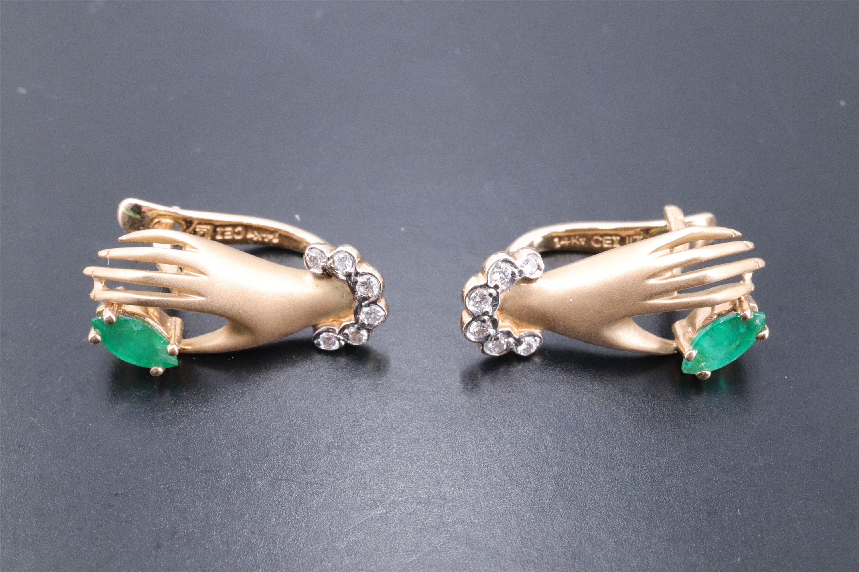 A pretty pair of contemporary novelty earrings modelled as a lady's cuffed hands clinching