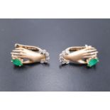 A pretty pair of contemporary novelty earrings modelled as a lady's cuffed hands clinching
