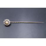 An antique pearl and diamond daisy-head stick pin, the pearl approx 4 mm, 10 mm overall, set on