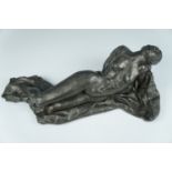 A late 20th Century cold cast bronze female nude sculpture, posed recumbent with her head back,