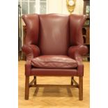 A quality reproduction George III hide upholstered wing-back armchair