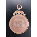 A 9 ct rose gold prize fob medallion, bearing a monogram, verso engraved "BSSSL 1911 - 1912", 4.9 g