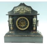 A monumental black slate mantle clock, having a drum movement striking on a gong, the case having