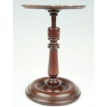 A 19th Century turned mahogany revolving stand, 15 x 22 cm