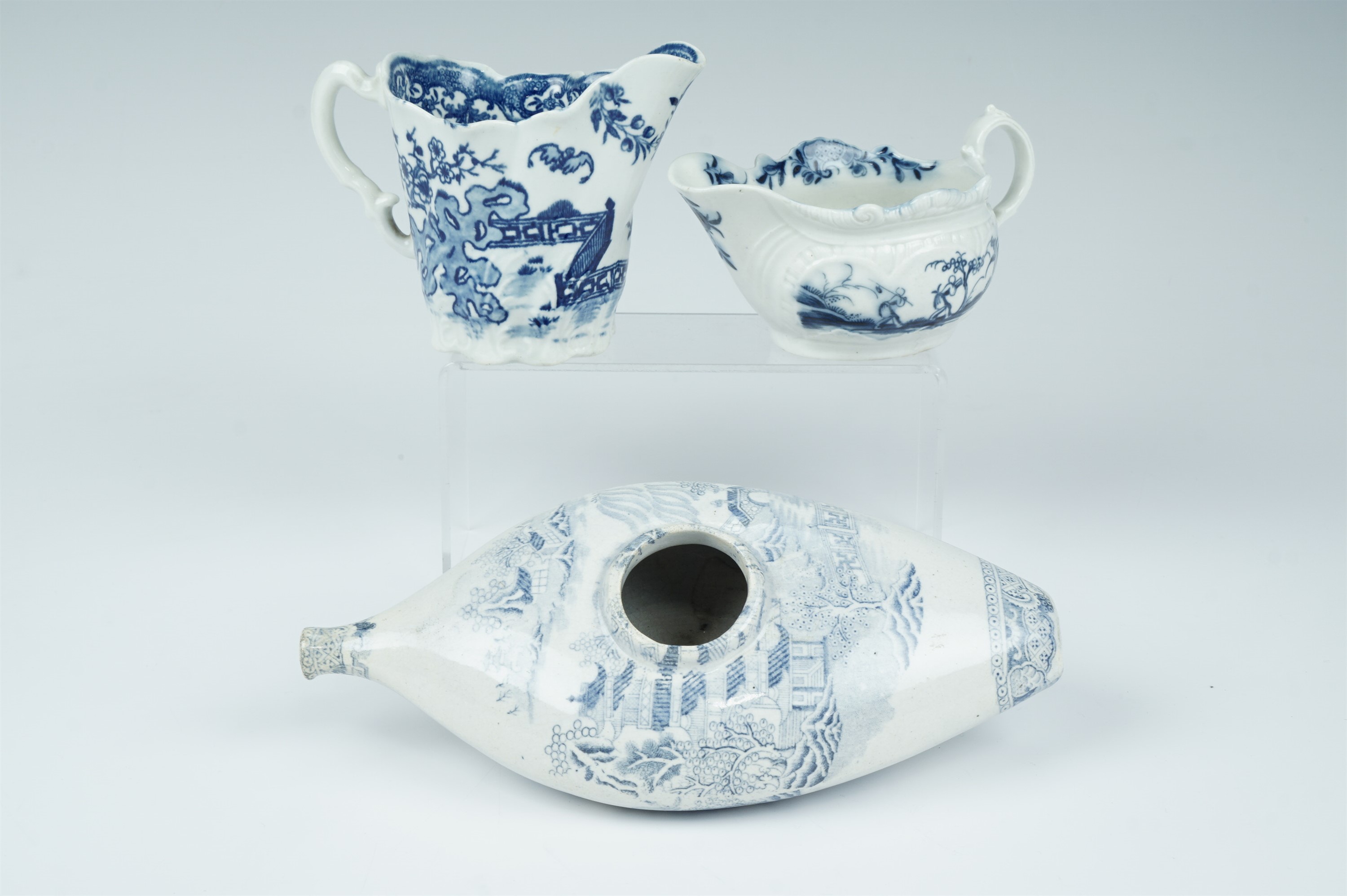 Two 18th Century Worcester moulded blue and white milk jugs, bearing underglaze crescent and