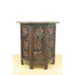 An Indian carved hardwood octagonal folding table, 62 cm x 64 cm