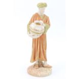 A late 19th Century Royal Worcester blush ivory figure of an Arab standing with a vase, model number