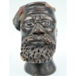 A late 19th / early 20th Century diminutive clay bust of a Zulu warrior, wearing an umghele head