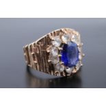 A sapphire and 9 ct gold ring, having an 8 mm x 6 mm blue sapphire above and surrounded by 10