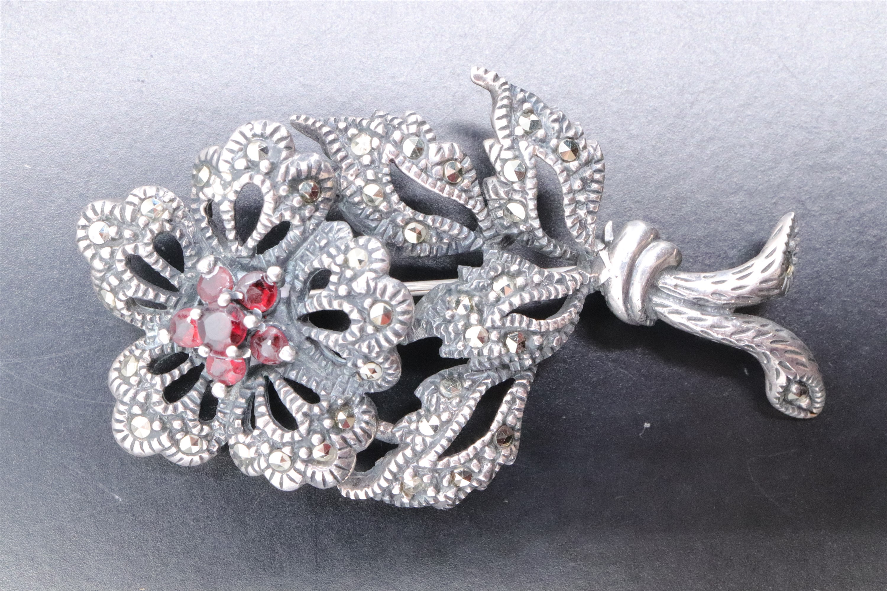 A white metal marcasite floral brooch, set with a cluster of six garnets, and a similar costume - Image 3 of 6