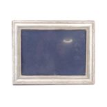 A late 20th Century silver faced photograph frame, having a convex frame with a ribbon and reed