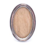 An silver fronted oval photograph frame, oak back and hinged stay, Birmingham, 1919, 13 x 8 cm sight