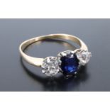 A sapphire and a diamond ring, comprising a central cushion cut sapphire of approx 0.5 ct claw-set