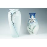 Two late 20th Century relief moulded porcelain vases by Franz, bearing amaryllis and dolphins,
