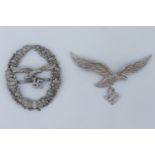 A German Third Reich Luftwaffe marksmanship lanyard badge together with a cap badge, (latter a/f)