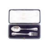 A George V cased silver christening set, having stylized shell form terminals and bearing a monogram