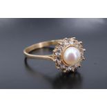 A pearl and 14 ct yellow metal dress ring, the pearl of approx 6 mm bezel-set within a frame of