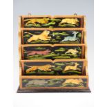 A late 20th Century Indian stationary rack, having parcel gilding and decorated with paintings of