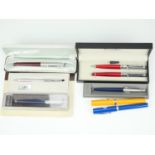 A 1950s cased Parker fountain pen, together with ball point pens including Cross, Sheaffer,