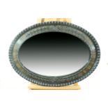 A George oval bevel-edged wall mirror in broad moulded and ebonised frame, 66 cm x 92 cm