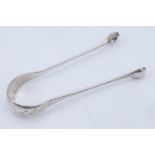 A pair of 19th Century silver sugar tongs, bearing bright cut engraving and a monogram to the bow,