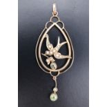 A Belle Epoque openwork peridot, seed pearl and 9 ct yellow metal open-work pendant, modelled as a