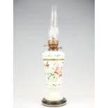 A Victorian hand painted milk glass oil lamp, depicting a song bird among flowers, with twin wick