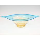 A large studio free-blown glass table centrepiece, of organic form, its pale amber body having a
