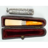 An Edwardian silver mounted meerschaum and amber cheroot holder, in leather covered case, and a