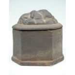 A Victorian cast iron tobacco box, of plain eight sided form, the lid bearing a moulded depiction of