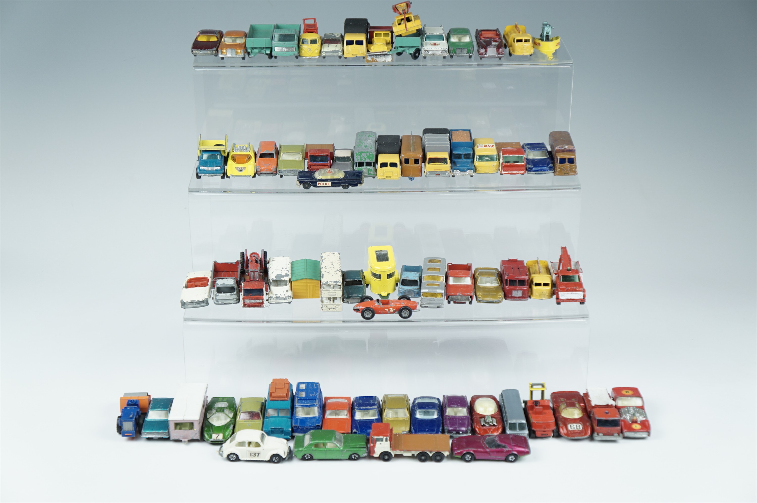 A quantity of Lesney and Matchbox play-worn diecast metal cars, wagons including a greyhound bus,