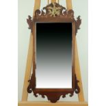 An old reproduction 18th Century mahogany fret mirror, having a gilt Ho-Ho bird crest, 80 cm x 44