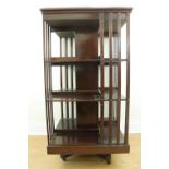 A late Victorian / Edwardian Sheraton Revival inlaid mahogany revolving book stand of uncommonly