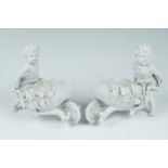 A pair of late 19th Century Volkstedt blanc de chine articulated porcelain figures of putti
