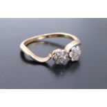 A vintage double daisy head diamond ring, the two clusters each of approx 5 mm, set on 18 ct gold,