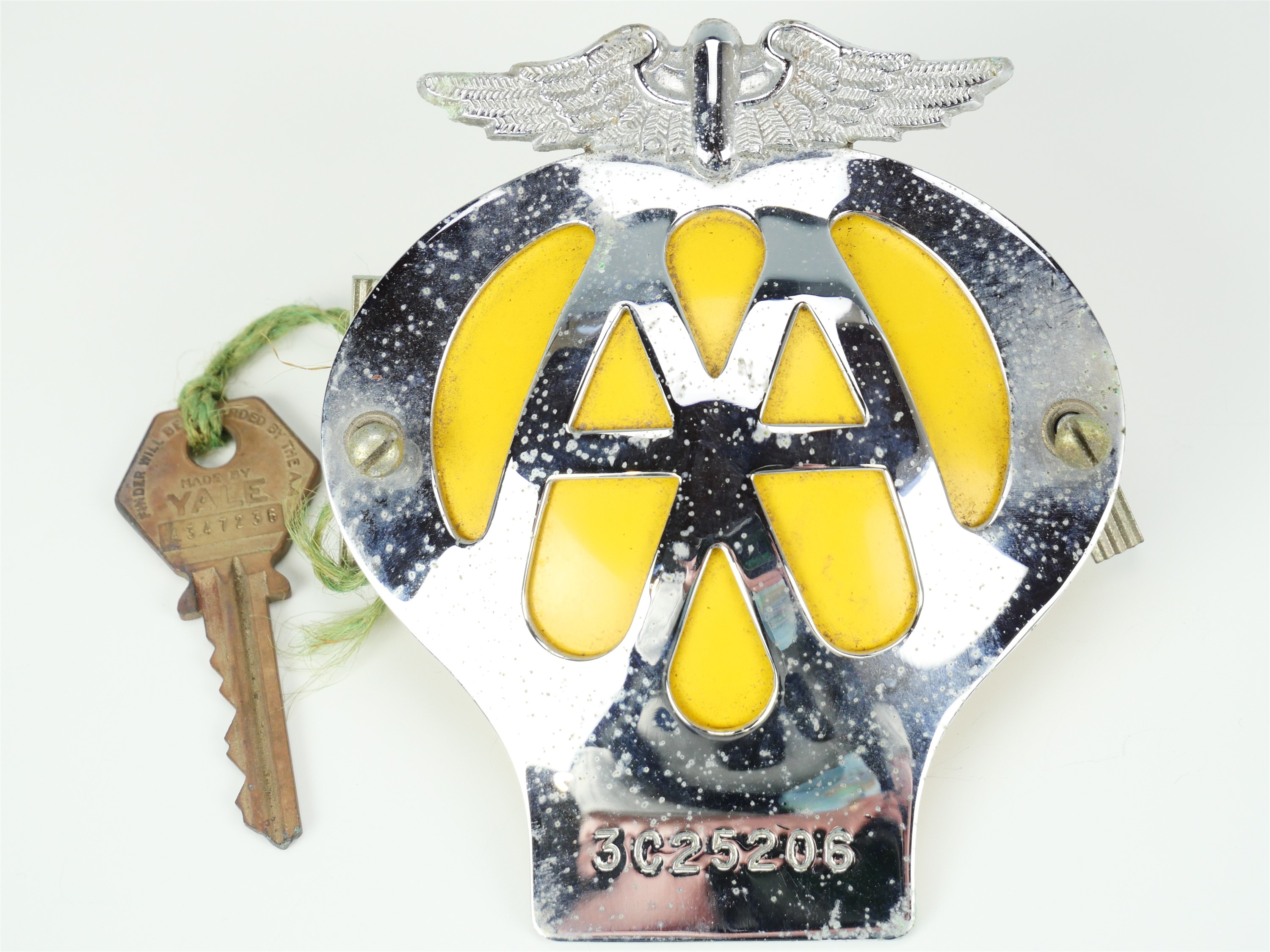 An AA car badge and key