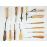 A group of vintage rug making and textile working tools, largely having turned wood handles,